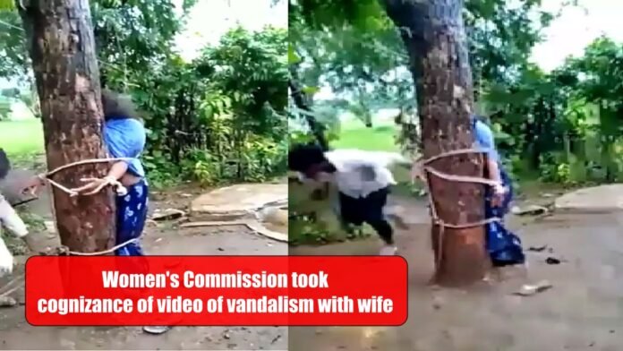 woman being tied to a tree and beaten up
