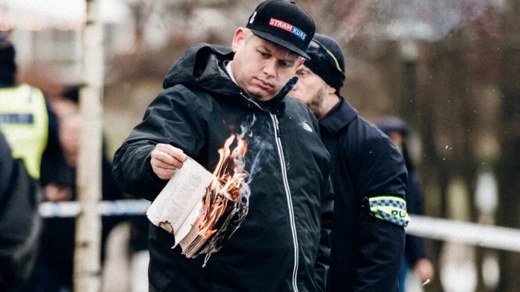 Swedens far-right leader burns Quran